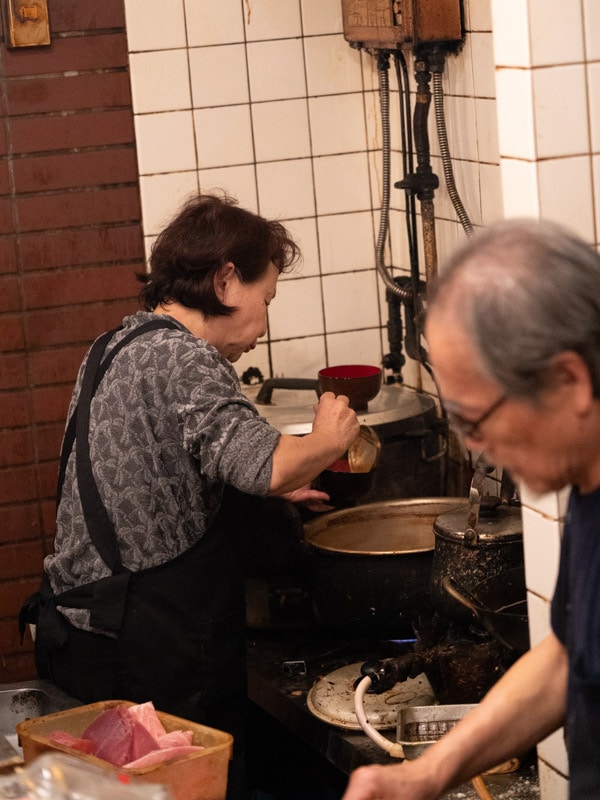 Preparing bowls of miso soup