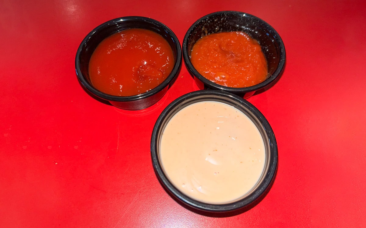 Two types of ketchup and a fry sauce