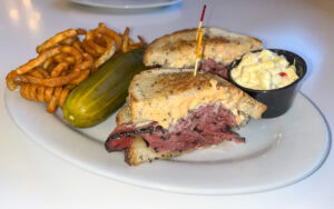 The Goodman with curly fries, macaroni salad, and pickle, Bagelmania, Las Vegas, Nevada